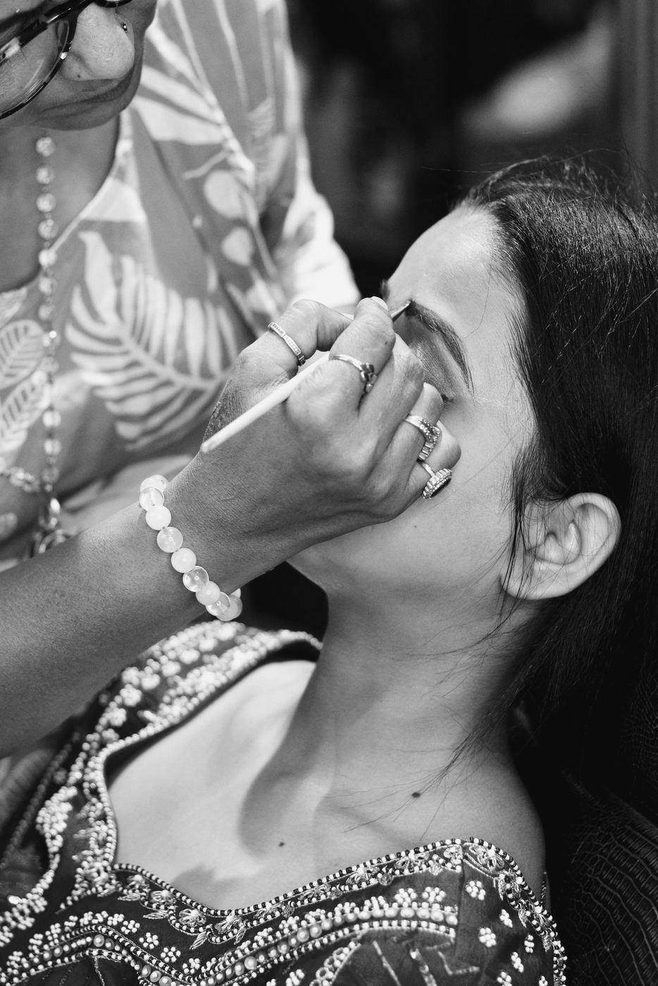Make-up artist shaping a woman's brows
